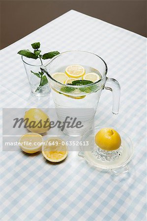 Lemons, herbs and pitcher of water Lemons, herbs and pitcher of water