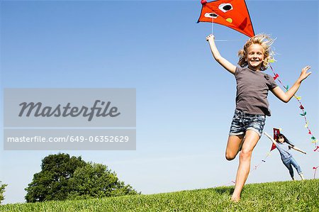 Girls playing with kites outdoors