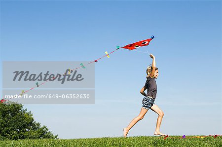 Girl playing with kite outdoors