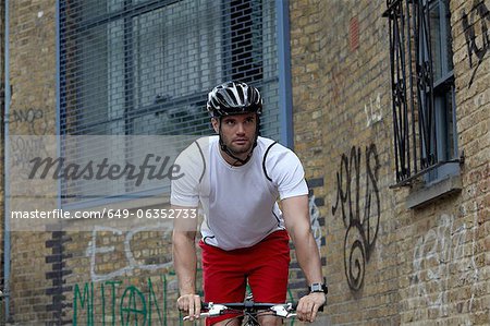 Man bicycling on city street