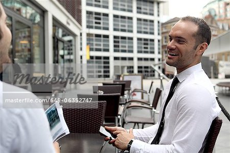 Businessmen talking at cafe