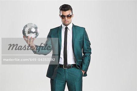 Businessman holding disco ball