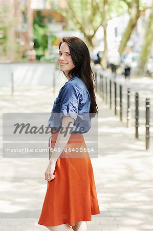 Smiling woman standing on city street