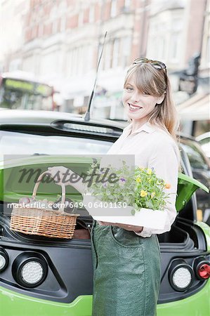 Woman loading produce into car