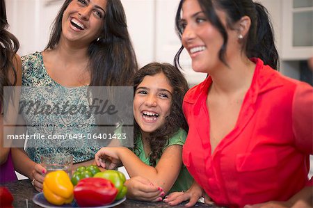 Sisters laughing together in kitchen