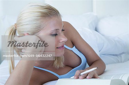 Woman reading book in bed