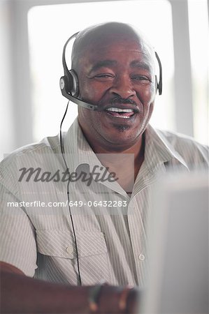 Businessman wearing headset at desk