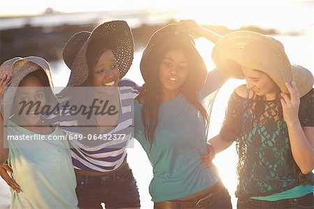 Women wearing sun hats on beach
