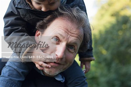 Father carrying son on his shoulders
