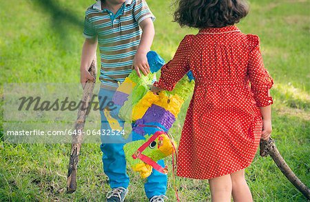 Children opening pinata at party