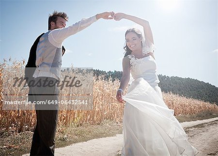 Newlywed couple dancing outdoors