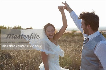 Newlywed couple dancing outdoors
