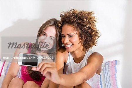Women taking picture with cell phone