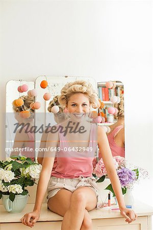 Smiling woman sitting on vanity