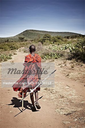 Maasai man walking on dirt road