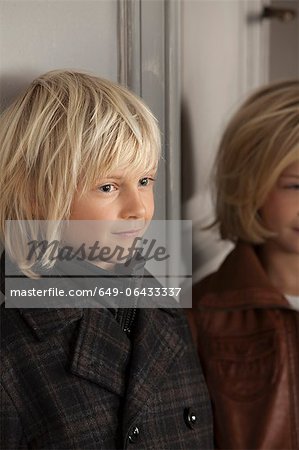 Children wearing winter coats indoors