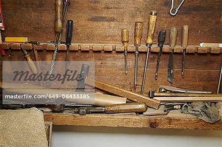 Chisels and wood on workbench