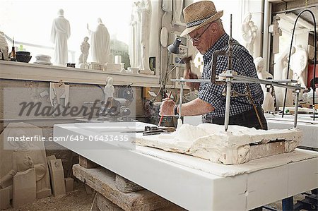 Worker chiseling slab of stone