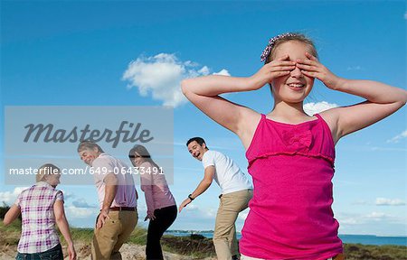 Family playing hide and seek outdoors