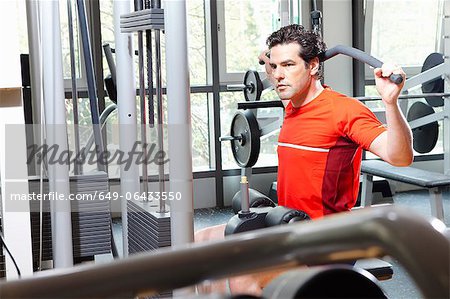 Man using exercise equipment at gym