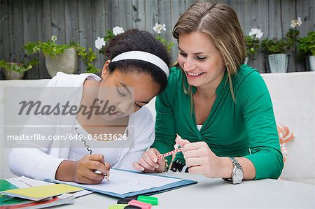 Student working with teacher outdoors