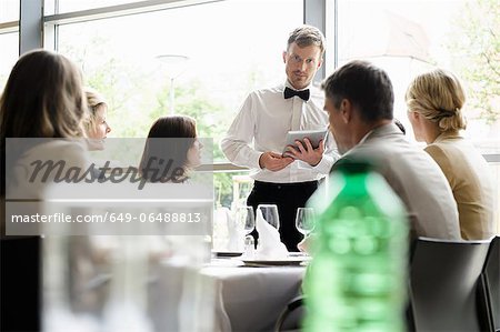Waiter taking order with tablet computer
