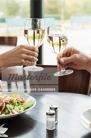 Couple toasting each other at cafe