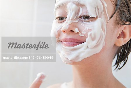 Girl rubbing moisturizer on her face