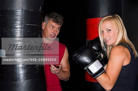 Boxer working with trainer in gym