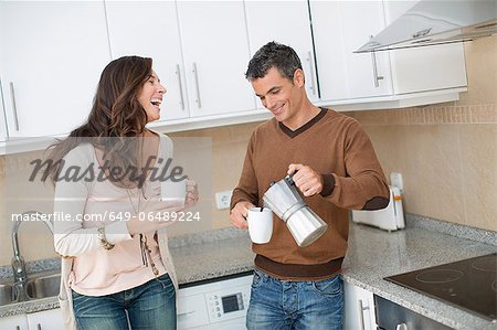 Couple having coffee in kitchen