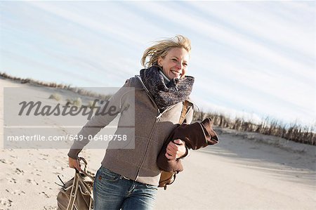 Smiling woman walking on beach