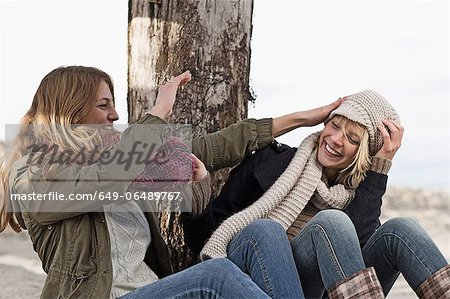 Smiling women playing on beach