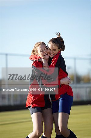 Team members hugging on field