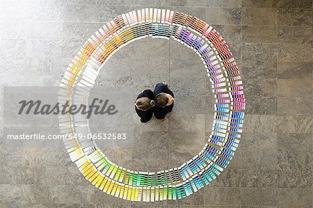 Business people with paint swatches Business people with paint swatches