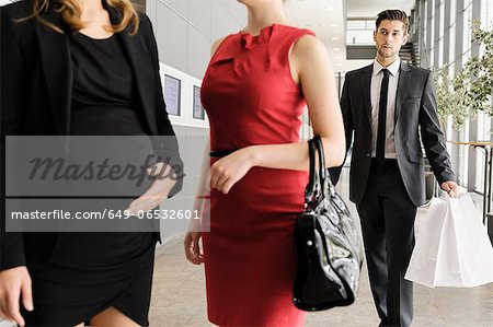 Businessman watching colleagues in lobby