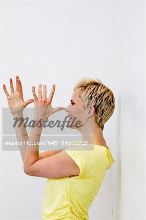 Smiling woman making face with hands