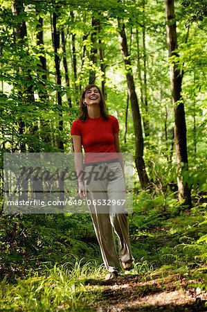 Woman walking in forest