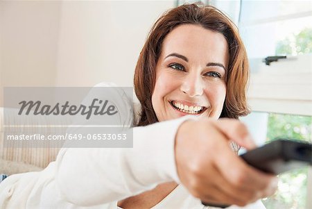 Smiling woman watching television