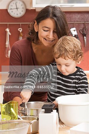 Mother and son cooking in kitchen