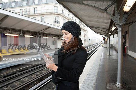 Woman using tablet computer on platform