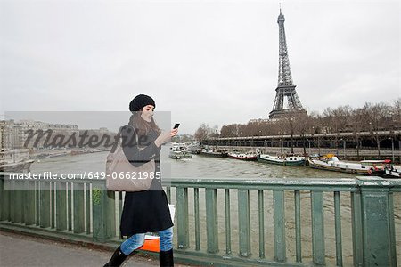 Woman using cell phone on waterfront