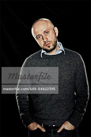 Man standing with hands in pockets Man standing with hands in pockets