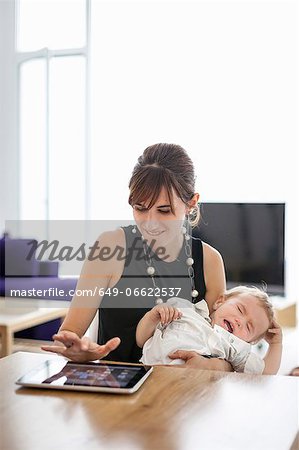 Businesswoman holding crying son