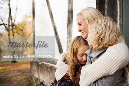 Mother and daughters sitting outdoors Mother and daughters sitting outdoors