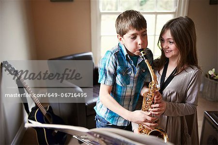 Children playing with saxophone