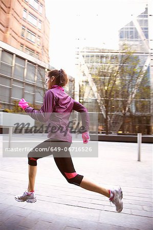 Woman running on city street