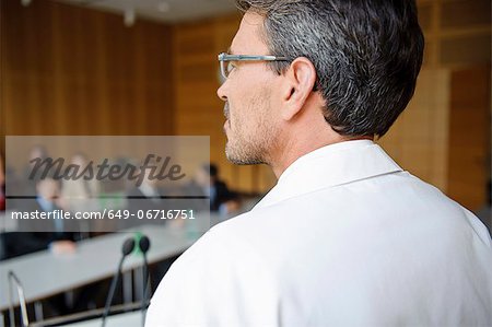 Doctor addressing audience in room