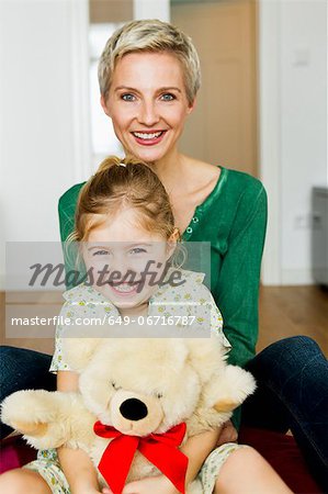 Mother and daughter sitting on floor