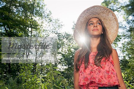 Teenage girl wearing straw hat outdoors