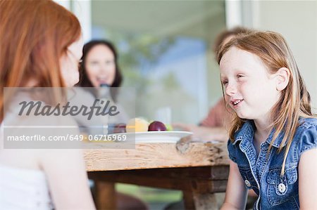 Girls talking at breakfast table